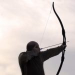 Archer firing arrow